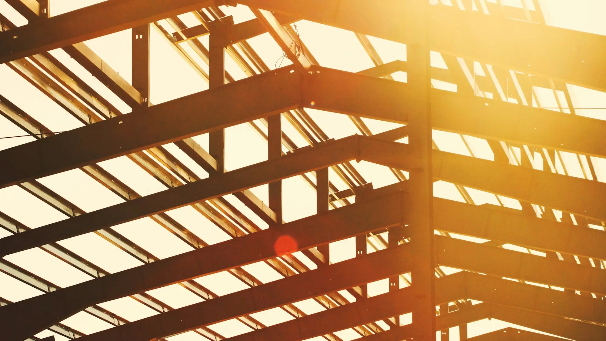 Steel frame of a commercial building in warm light (placeholder photo)