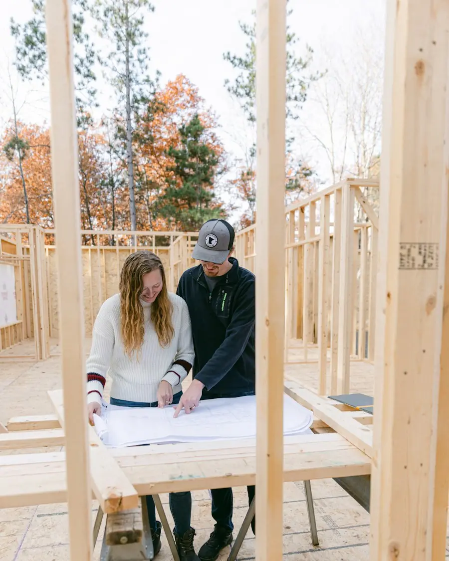 Shane walking a client through plans on a framed job site (placeholder photo)